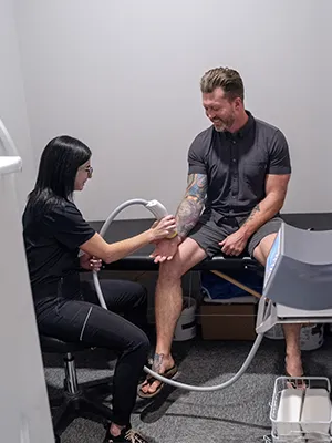 Chiropractic--Shockwave-Therapy-on-Patient